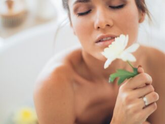 topless woman holding white flower